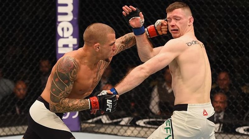 Dustin Poirier (L) lands a punch on Joseph Duffy
