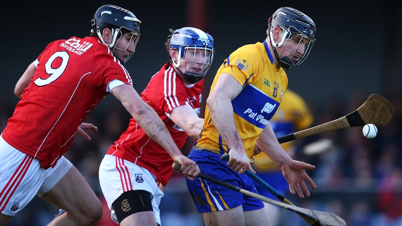 Clare's John Conlon is challeneged by Mark Ellis and Damian Cahalane of Cork