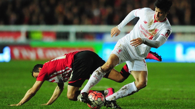 Joao Carlos Teixeira of Liverpool evades Alex Nicholls of Exeter City