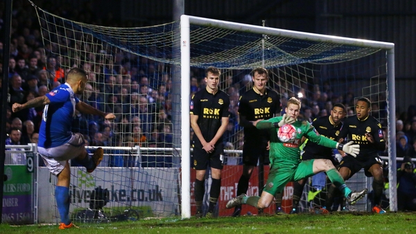 Ben Amos of Bolton Wanderers makes a save from a freekick of Jai Reason of Eastleigh
