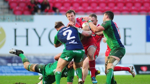 Scarlets' Hadleigh Parkes is tackled by Connacht's Ultan Dillane