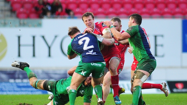 Scarlets' Hadleigh Parkes is tackled by Connacht's Ultan Dillane