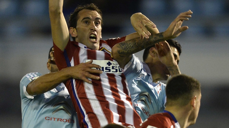 Atletico Madrid's Uruguayan defender Diego Godin rises for a header