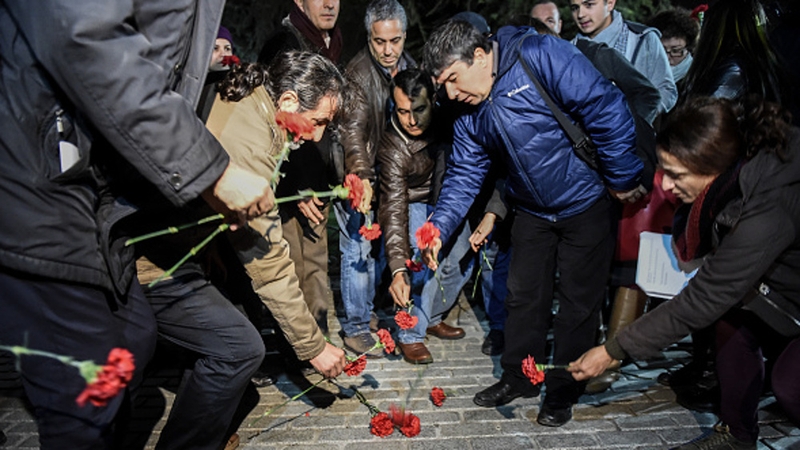 People lay flowers at the scene of the blast in the Sultanahmet district