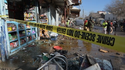Security officials inspect the scene of the bomb