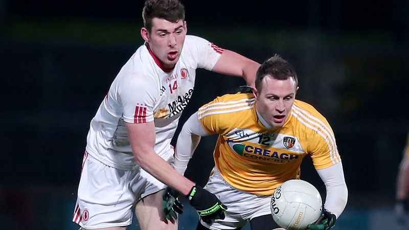 Tyrone's Padraig McNulty with Antrim's Michael McCann