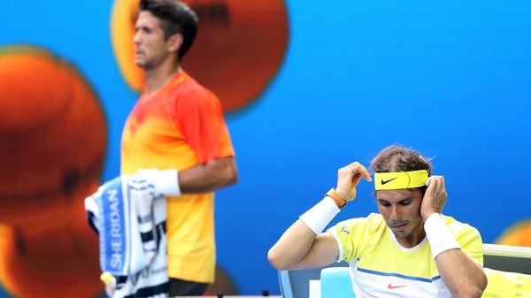 Fernando Verdasco of Spain walks behind Rafael Nadal
