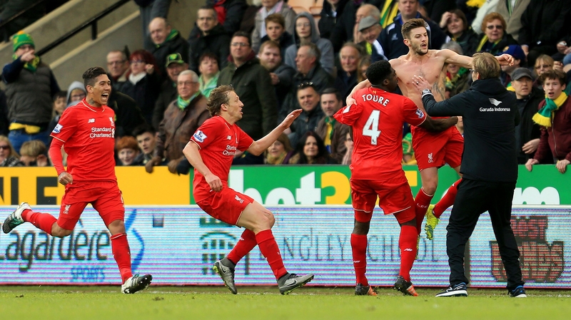 Adam Lallana (2nd R) of Liverpool celebrates scoring his team's fifth goal with manager Jurgen Klopp (1st R) and team-mates