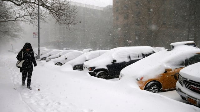 A woman walks through the snow on the Lower East Side of Manhattan