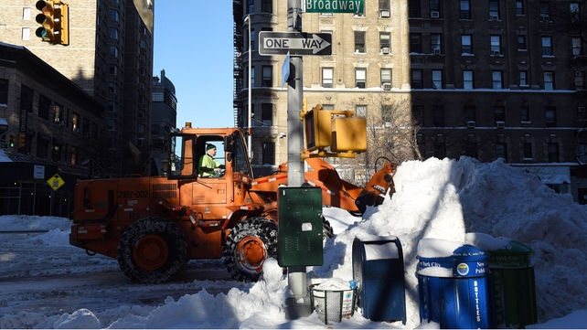 Heavy equipment clears the street of snow on the Upper West Side in New York City