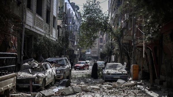 Locals inspect the aftermath of an airstrike by government forces in Douma, on the outskirts of Damascus