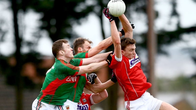 Mark Collins of Cork beats Mayo's Shane Nally and Jason Gibbons to a ball