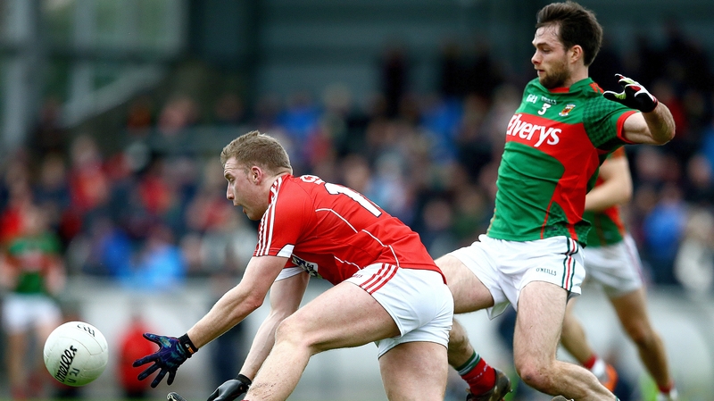 Brian Hurley from Cork beats Mayo's Ger Cafferkey to a ball at Pairc Ui Rinn