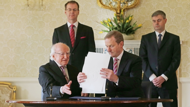 'So that's that': President Higgins and Taoiseach Enda Kenny sign the papers to officially dissolve the 31st Dáil