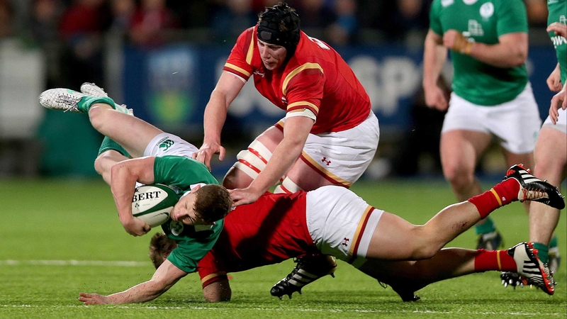Ireland's John Poland tackled by Harri Millard
