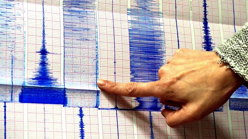 A member of the Seismological Observation Centre points to a graph after an earthquake and aftershocks hit southern Taiwan