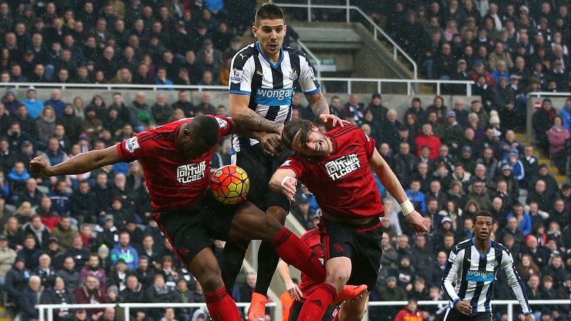 Newcastle's Aleksandar Mitrovic gets between Victor Anichebe (L) and Jonas Olsson
