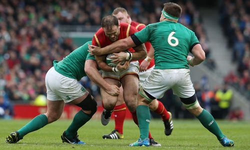 Jamie Roberts of Wales is tackled by Jack McGrath and CJ Stander