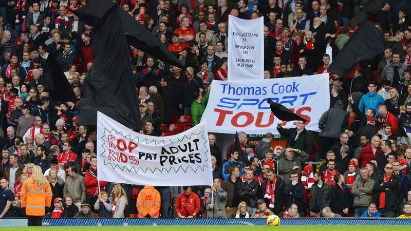 Fans in the Kop display banners and black flags in protest to ticket price hikes