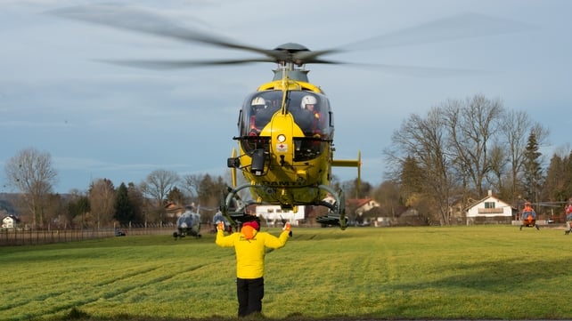 A helicopter leaves the scene of the crash