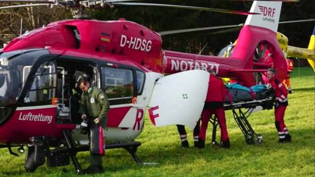 Emergency services remove an injured passenger from the scene