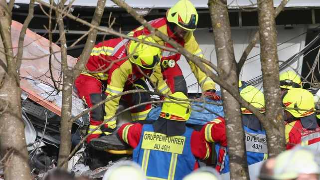 Rescue workers are seen in protective clothing