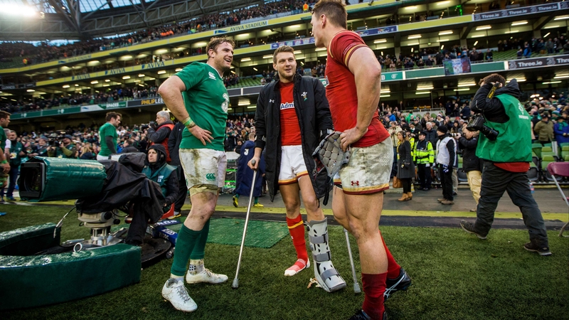 An injured Dan Biggar chats with Wales team-mate Jonathan Davies and Ireland's Jamie Heaslip after Sunday's draw at the Aviva Stadium
