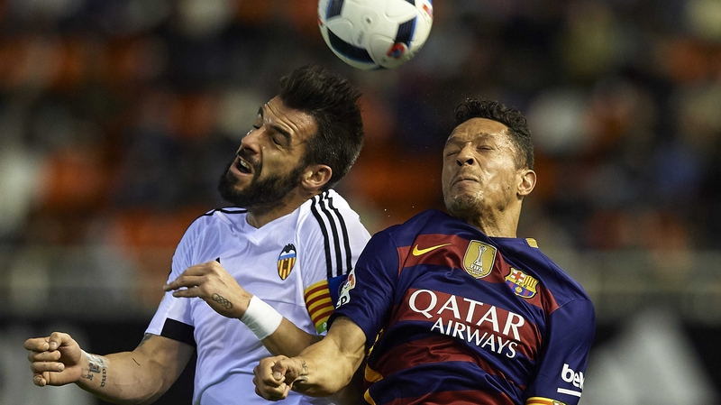 Alvaro Negredo (L) rises for a header with Adriano of Barcelona