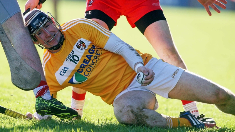 Antrim's Eddie McCloskey tries to hold possession among a sea of legs