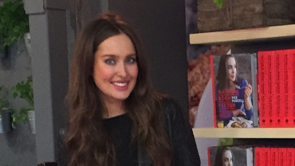 Roz pictured beside her number one bestselling cook book, Natural Born Feeder