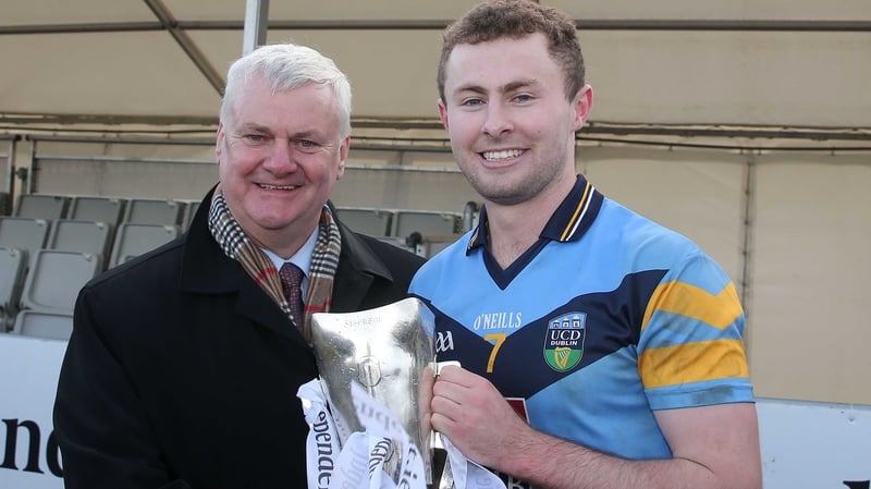 Jack McCaffrey (R) poses with the Sigerson Cup and GAA President Aogán Ó Fearghaíl last February