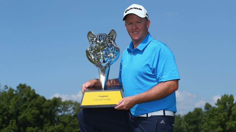 Marcus Fraser of Australia poses with the winning trophy in Malaysia
