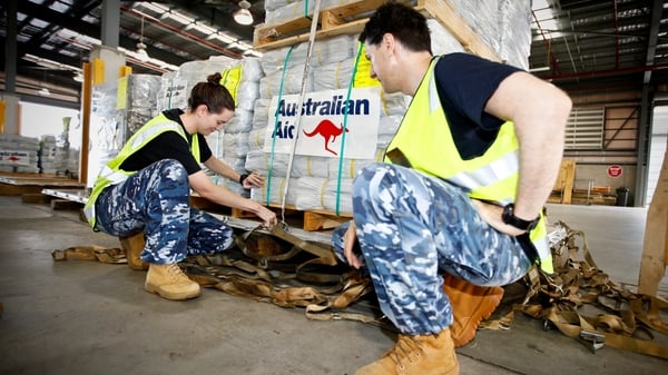 Members of the Royal Australian Air Force prepare aid to be delivered to the cyclone-hit areas of Fiji