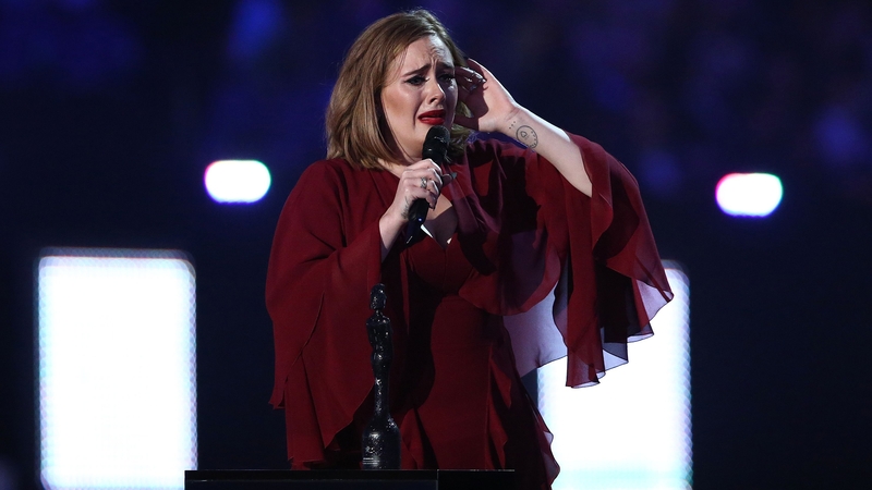 An emotional Adele picked up four Brit awards