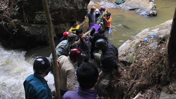 Rescuers carry one of three bodies of British tourists