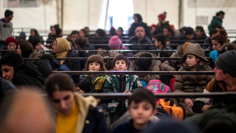 Iraqi migrants without valid documents wait at a transit centre near the Macedonian-Greek border