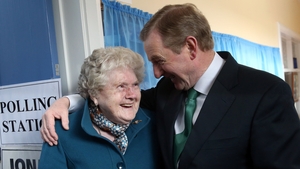 Taoiseach Enda Kenny meets Bridie McLoughlin on her 88th birthday after they both cast their votes at a polling station at St Anthony's School in Castlebar, Mayo