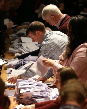 Ballot papers are verified as counting gets under way at the City Hall in Cork