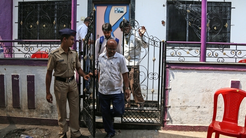 Police outside the house where the alleged murders took place