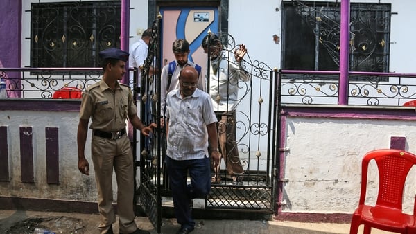 Police outside the house where the alleged murders took place