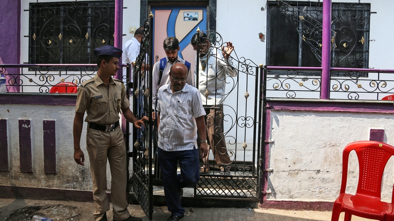 Police outside the house where the alleged murders took place