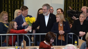 Sinn Féin's Gerry Adams is presented with flowers as he was declared elected at the Louth constituency count in Dundalk