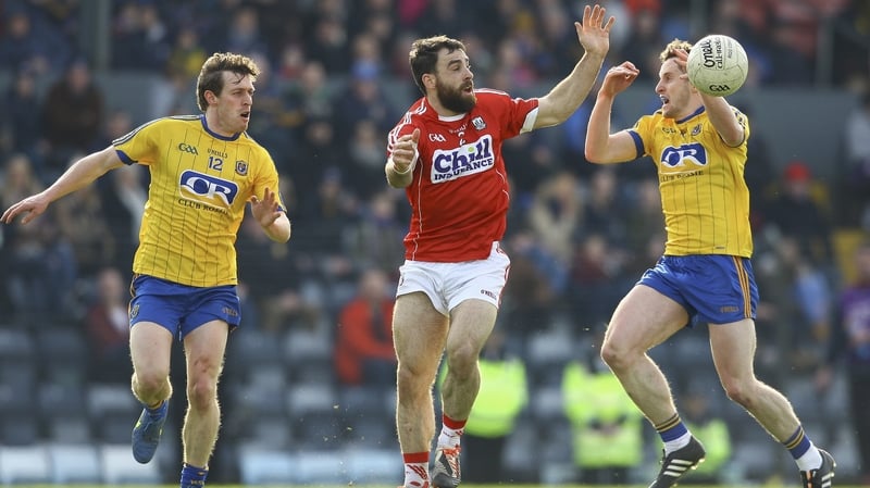 Cork's Colm O'Driscoll with Roscommon's Conor Devaney and double-goalscorer Ciaran Murtagh (R)