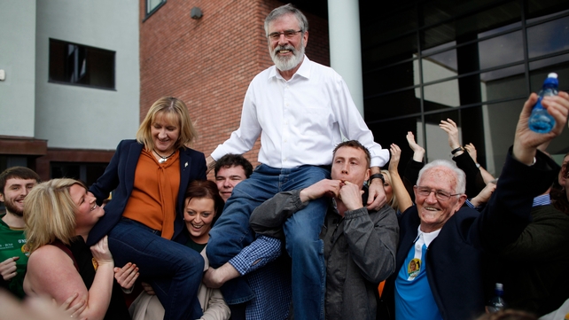 Sinn Féin's Gerry Adams and Sinn Féin Cllr Imelda Munster are held aloft outside the count centre in Dundalk after being elected in Louth