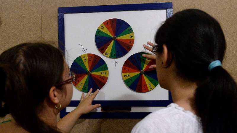 File image of people trying to solve a logical puzzle in Budapest