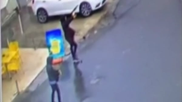 Two women caught on camera, one with a gun and the other with a grenade