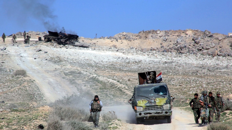 Pro-government forces pass through Khanasser, which is the sole link between government-held areas in and around Aleppo and the rest of the country