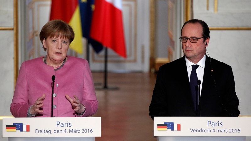 German Chancellor Angela Merkel and French President Francois Hollande speaking at a press conference in Paris