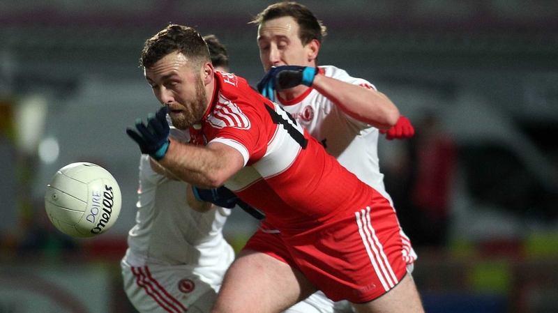 Derry's Emmett McGuckin and Tyrone's Colm Cavanagh scrap for possession