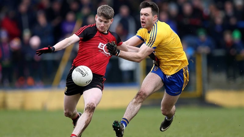 Ian Kilkbride and Conor Maginn battle for possession